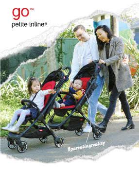family with two toddlers walking at a park garden pushing the go™ inline™ buggy
