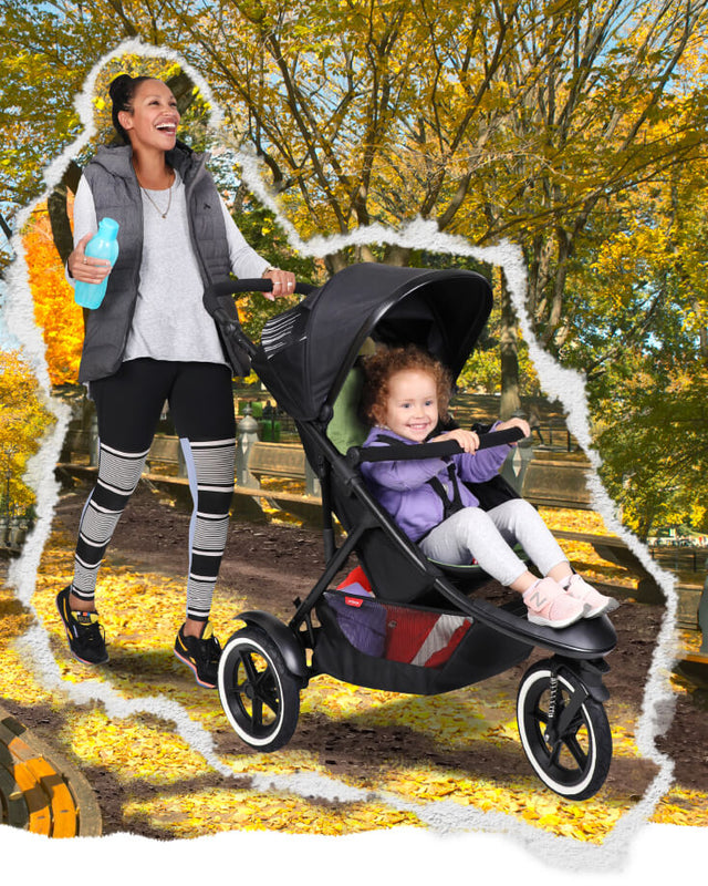 woman pushing toddler in sport™ 3 wheel buggy while strolling through parklands - philandteds