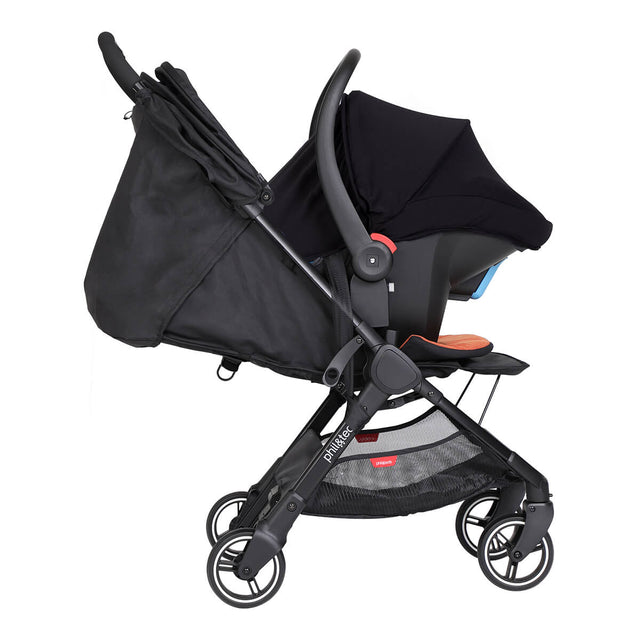 alpha™ infant car seat shown as a travel system using optional travel adaptors on a phil&teds® go™ buggy