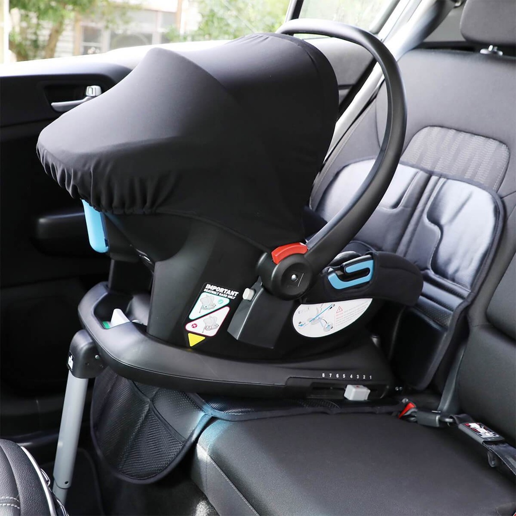 phil&teds vehicle seat mate shown in car under alpha car seat and base, protecting the car interior fabrics from spills and indentations